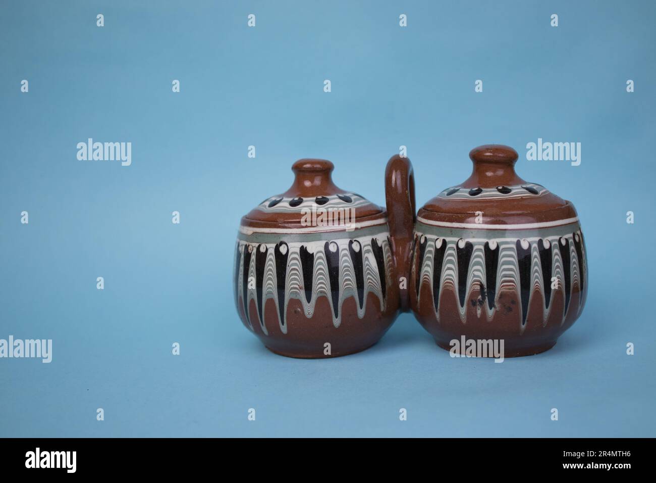 Historique, traditionnel, porte-épices, photographié sur le côté, placé sur un fond bleu. Banque D'Images