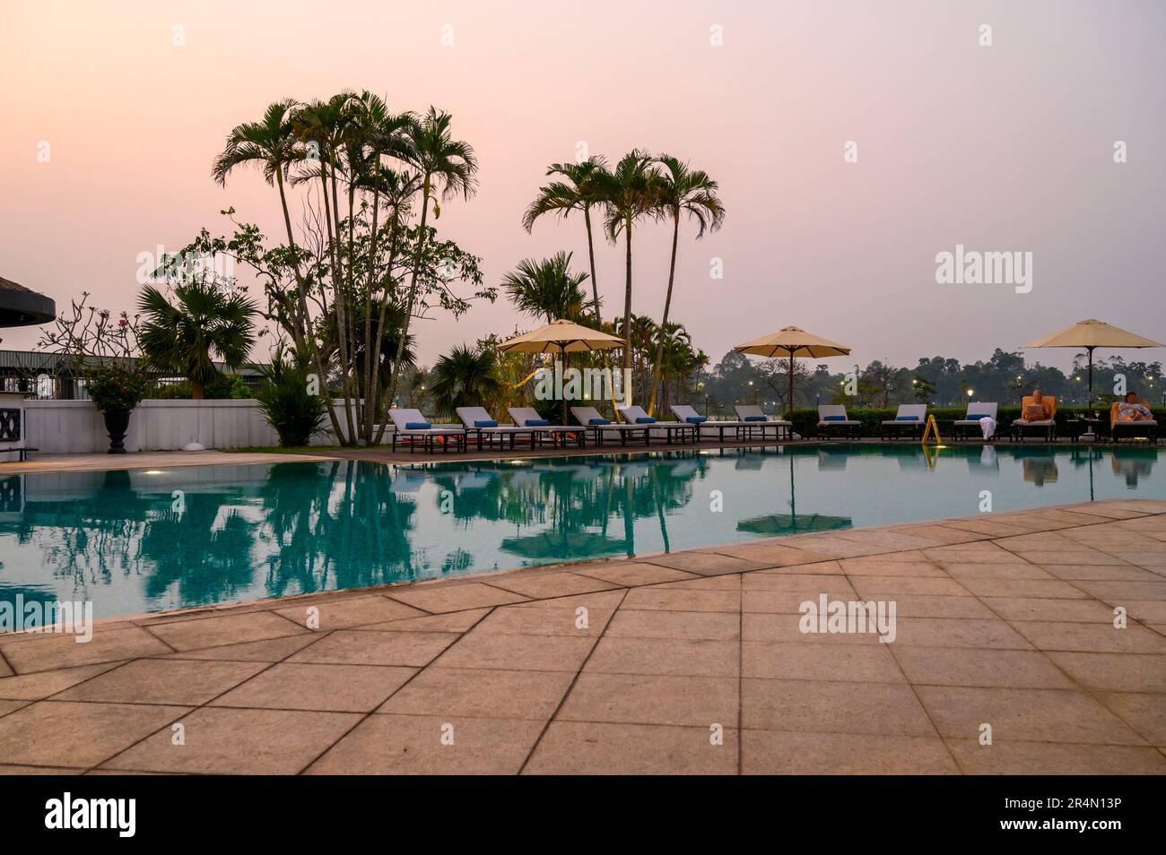 La piscine à la tombée de la nuit à l'hôtel Azerai la Residence à Hue, Vietnam. Banque D'Images