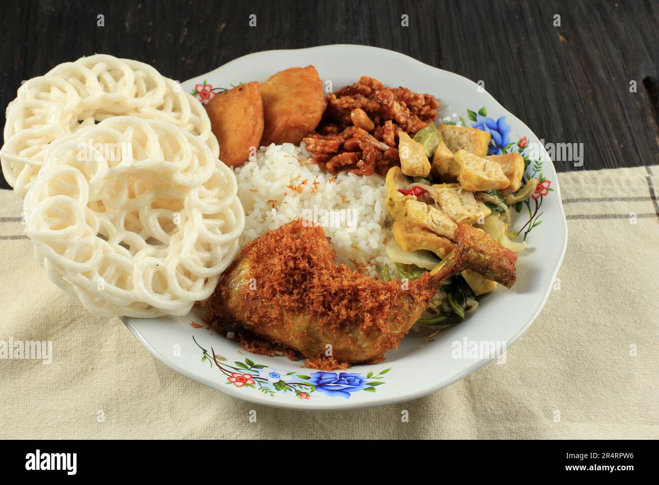 Nasi Warteg avec poulet frit Lengkuas, riz avec divers plats d'accompagnement et craquelins Banque D'Images