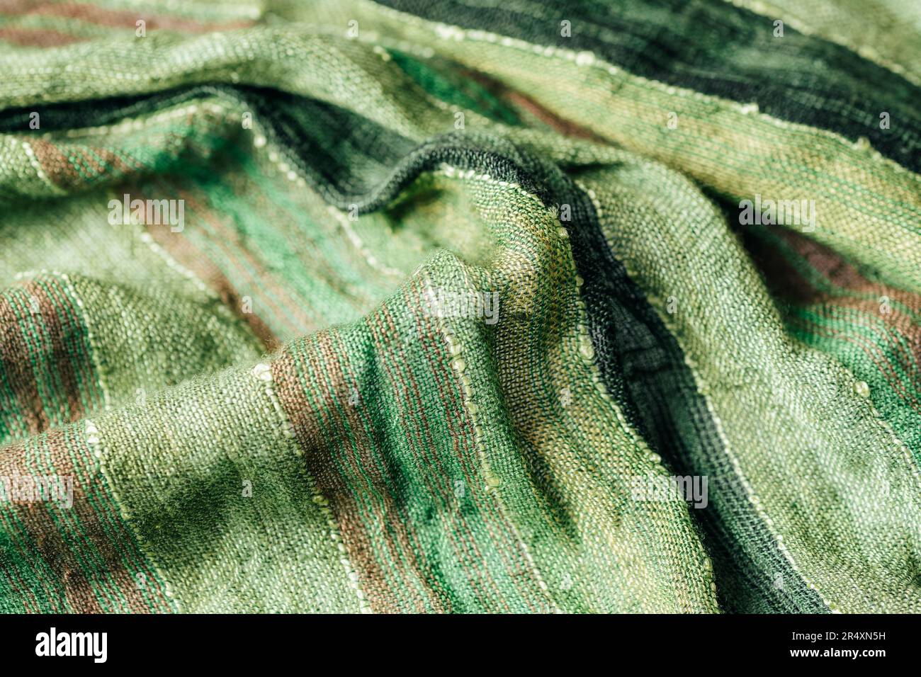 Texture du tissu du foulard vert. Tissu torsadé grossier, arrière-plan. Banque D'Images