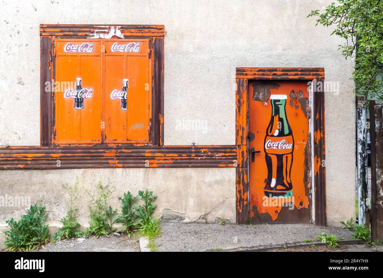 Bouteille de Coca-Cola sur les fenêtres et la porte en bois murale Tbilissi Géorgie Banque D'Images