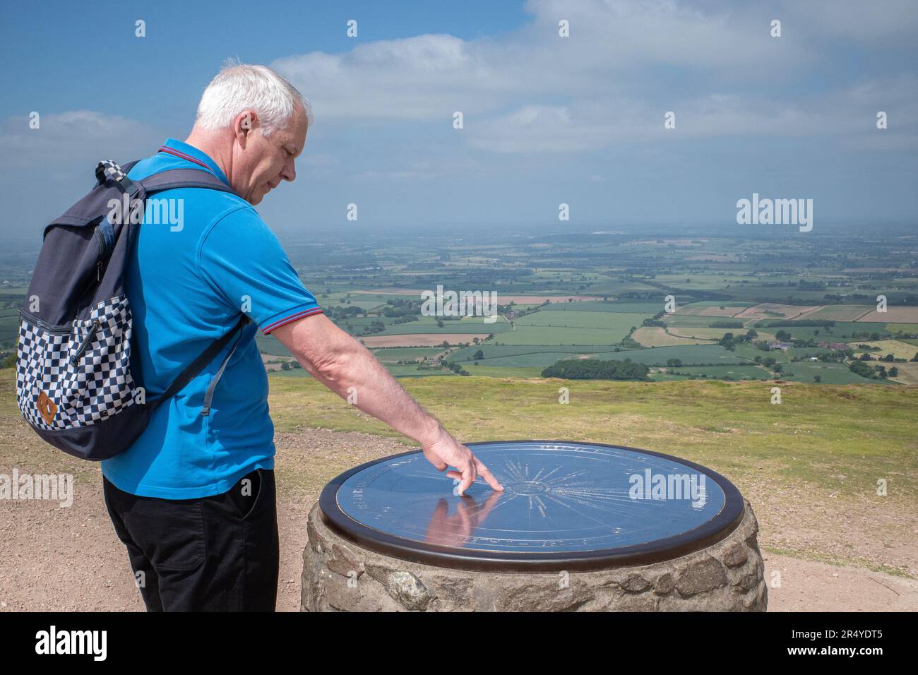 Un marcheur étudie un toposcope au sommet du Wrekin, une colline du Shropshire, en Angleterre. Banque D'Images