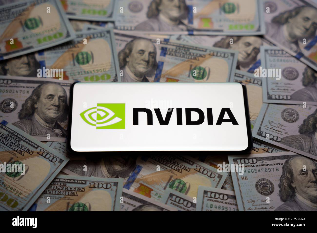 Logo NVIDIA vu sur le smartphone qui est placé sur une pile de billets en dollars américains. Concept. Mise au point sélective. Stafford, Royaume-Uni, 31 mai 2023 Banque D'Images