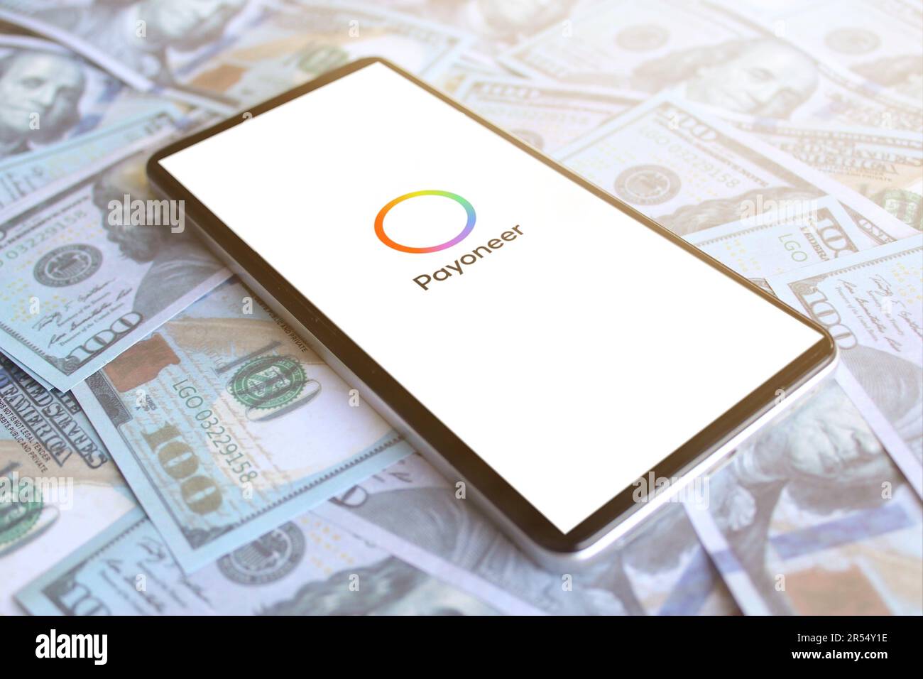 Logo Payoneer affiché sur le smartphone sur la pile d'argent. Concept de profit d'entreprise Banque D'Images