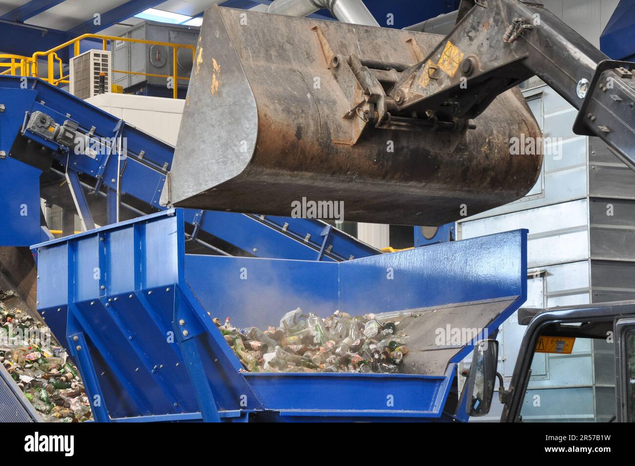 L'excavatrice qui charge les déchets dans une usine de recyclage des déchets est en train de trier les déchets, problèmes environnementaux. installation de tri des déchets, centre de tri des déchets Banque D'Images