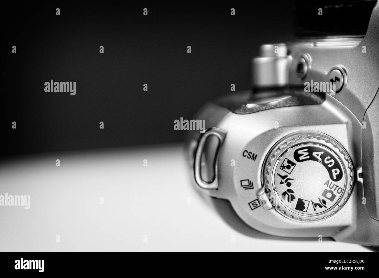 Cadran de mode sur les anciens appareils photo numériques : photographie en noir et blanc du cadran de mode sur un tableau blanc sur fond noir flou. Banque D'Images