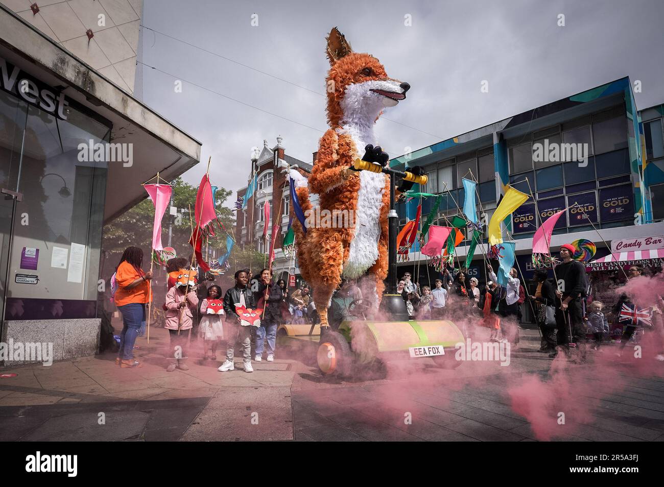 Londres, Royaume-Uni. 2nd juin 2023. Farrah le Fox, une marionnette de cinq mètres de haut sur un scooter géant, pose avec les habitants avant de partir autour de Woolwich pour célébrer les rues hautes de EnglandÕs cet été. Partie de Hi! Street Fest by Historic England, une commission nationale historique avec Emergency Exit Arts qui rassemble les gens pour célébrer whatÕs spécial sur nos rues hautes. Credit: Guy Corbishley/Alamy Live News Banque D'Images