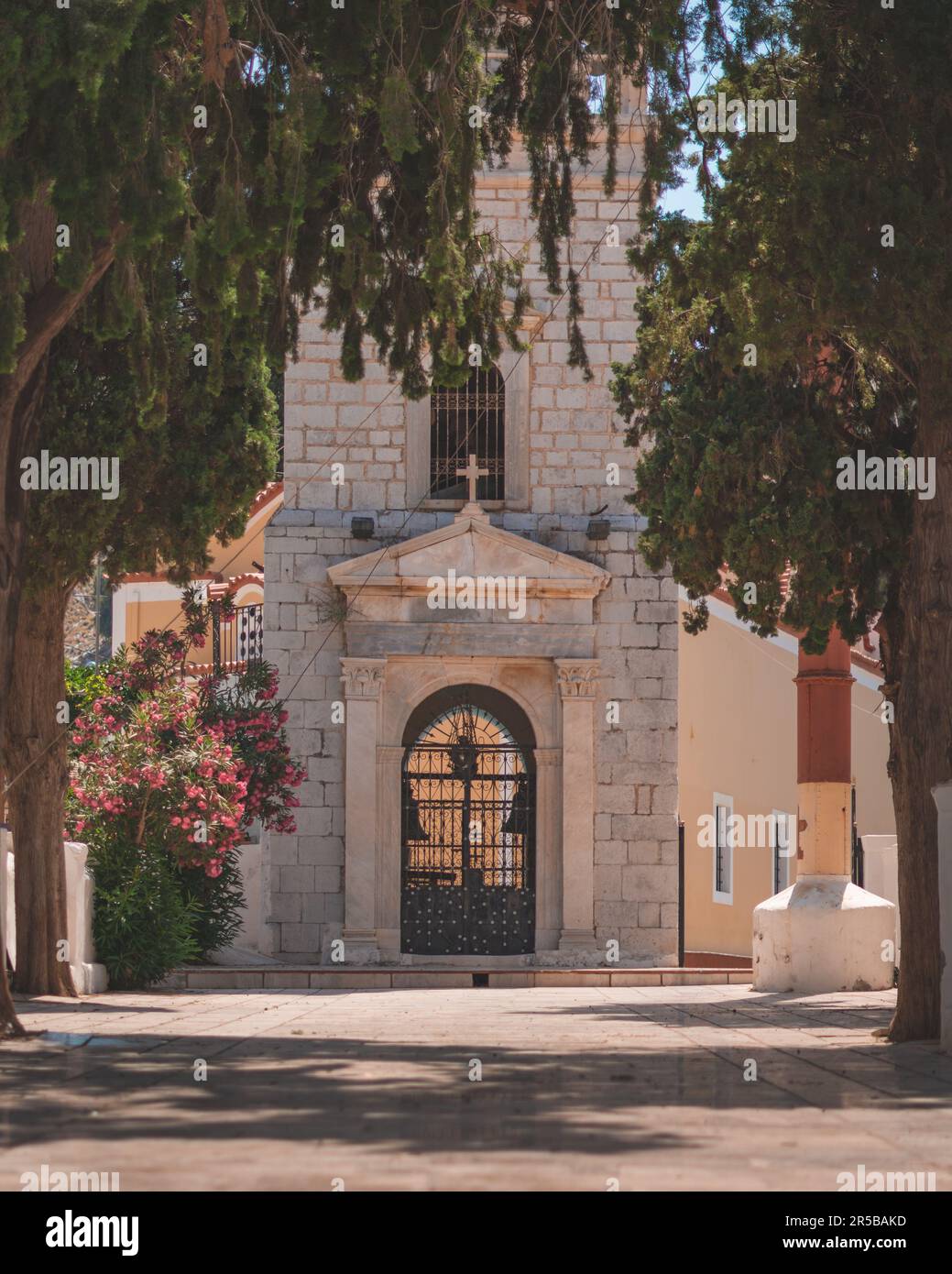 Une majestueuse vieille église en pierre avec une tour d'horloge complexe et de grandes portes en fer Banque D'Images