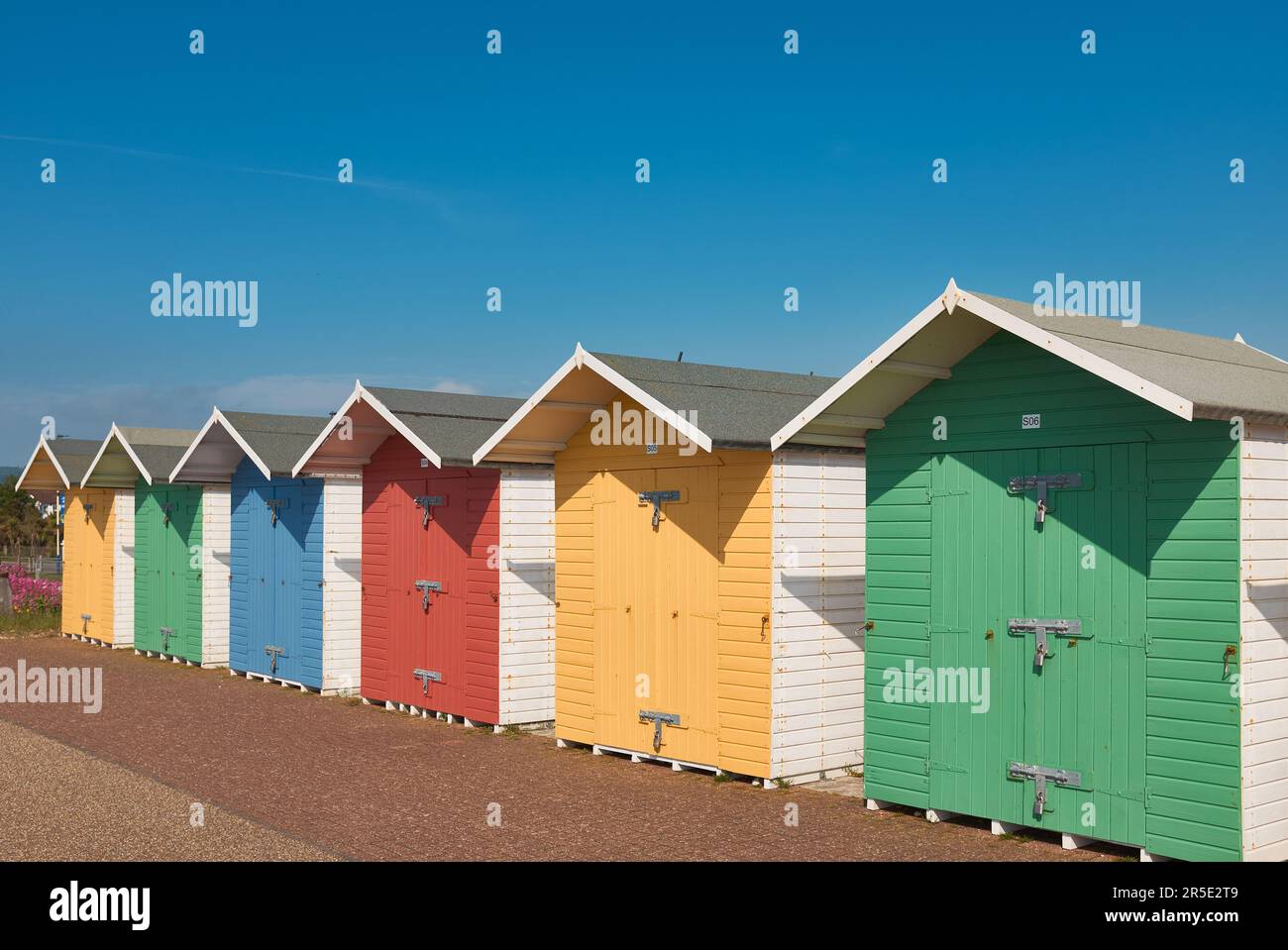 Cabines de plage multicolores à Eastbourne, sous un ciel bleu clair en été Banque D'Images