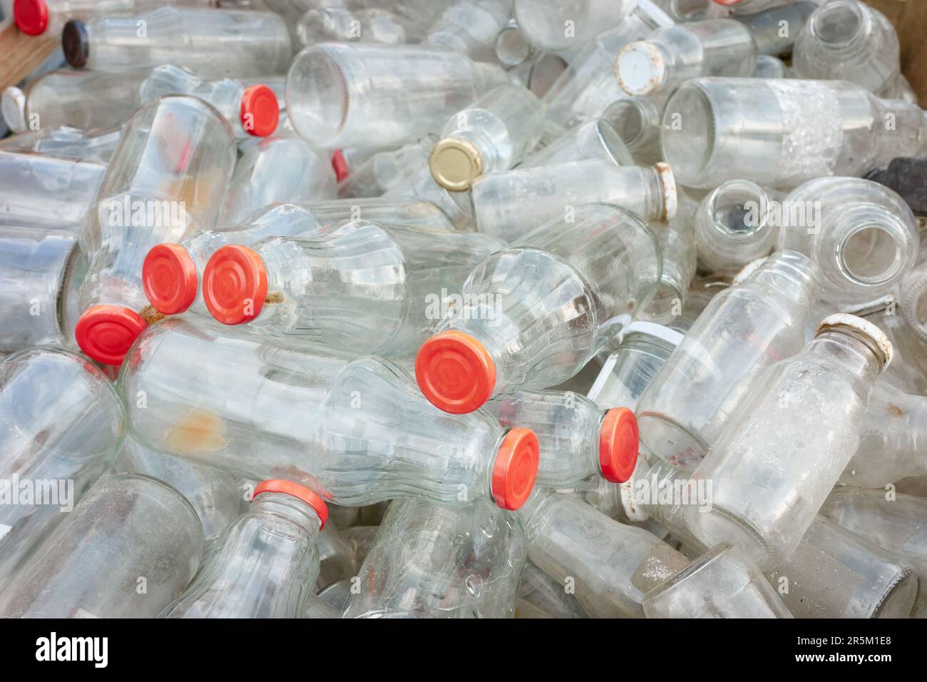 Bouteilles en verre vides utilisées stockées pour recyclage, mise au point sélective. Banque D'Images
