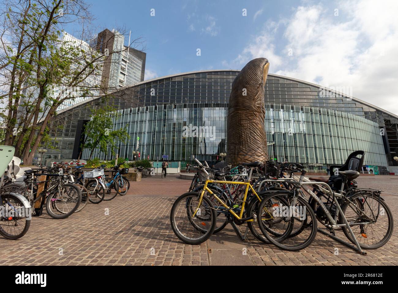 Vélos écologiques à Paris avec le pouce géant à la Défense au milieu du sol et architecture moderne derrière en fin d'après-midi soleil Banque D'Images