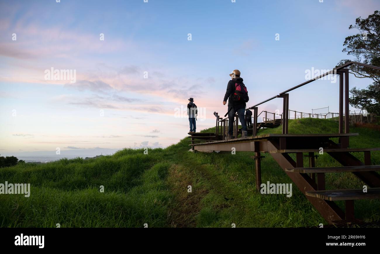 Les gens qui marchent sur la promenade surélevée autour du cratère au sommet de Mt Eden. Auckland. Banque D'Images