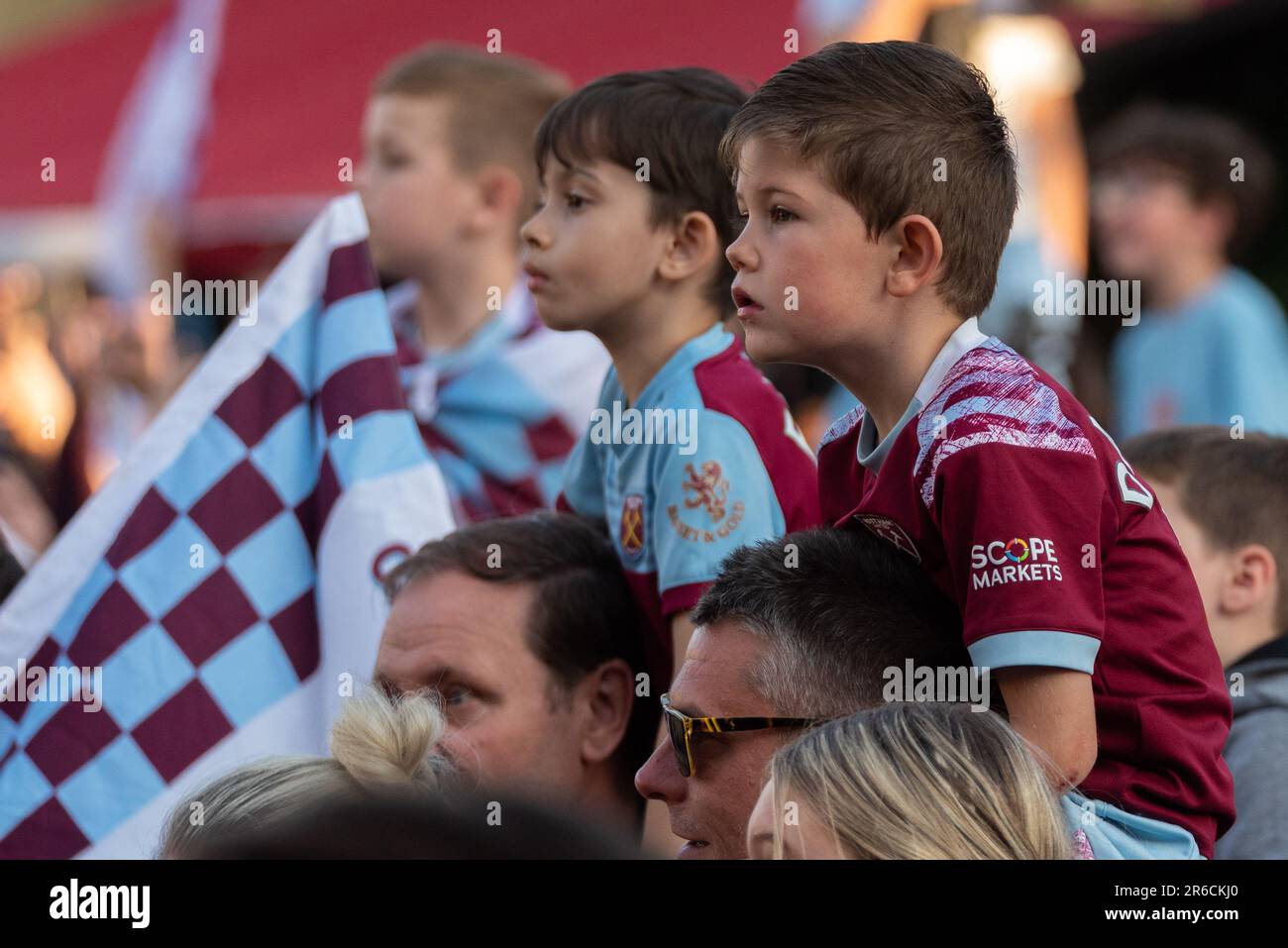 Newham, Londres, Royaume-Uni. 8th juin 2023. Les joueurs et le personnel du West Ham United football Club ont célébré la victoire du trophée UEFA Europa Conference League avec un défilé de victoire en bus à haut ouvert à travers le quartier, de la statue des champions près de l'ancien stade Boleyn Ground de l'équipe et se terminant à l'hôtel de ville de Stratford. Les fans ont tracé la route pour célébrer et encourager leur équipe. Garçons en répliques de chemises Banque D'Images