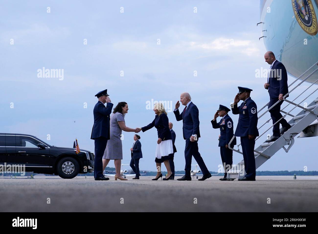 President Joe Biden and first lady Jill Biden walk down the steps of ...