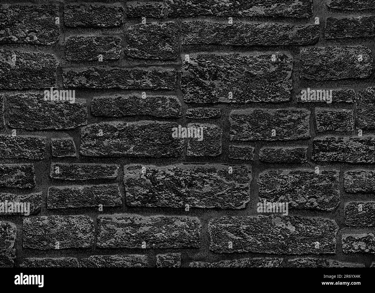 Mur en brique noire avec taches grises. Texture d'un mur sombre rugueux. Banque D'Images