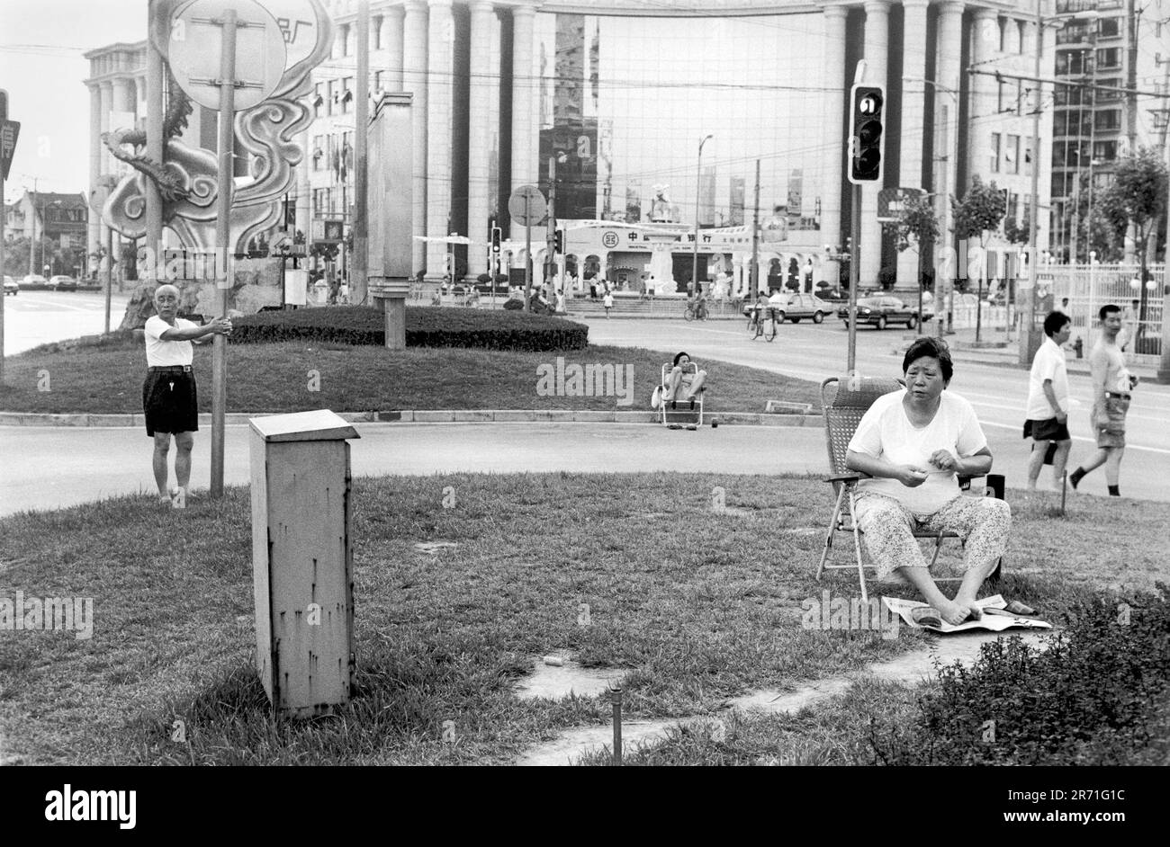 Shanghai Chine 2000. En été, la chaleur et l'humidité à Shanghai peuvent être étouffantes. Le soir, les résidents apprécient l'espace vert ouvert de la réservation centrale à Fuxing Dong lu. Ce quartier est à la jonction de la vieille ville chinoise et de la concession française. Ce dernier était célèbre pour ses platanes qui, en été, avaient l'ombre d'un bon accueil jusqu'à ce qu'ils soient emportés pour élargir les routes. 2000s HOMER SYKES Banque D'Images