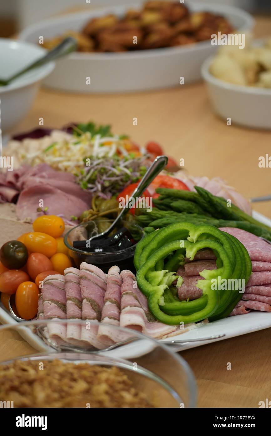 Un cliché vertical d'une table en bois avec un plateau rempli de viandes et légumes cuits Banque D'Images