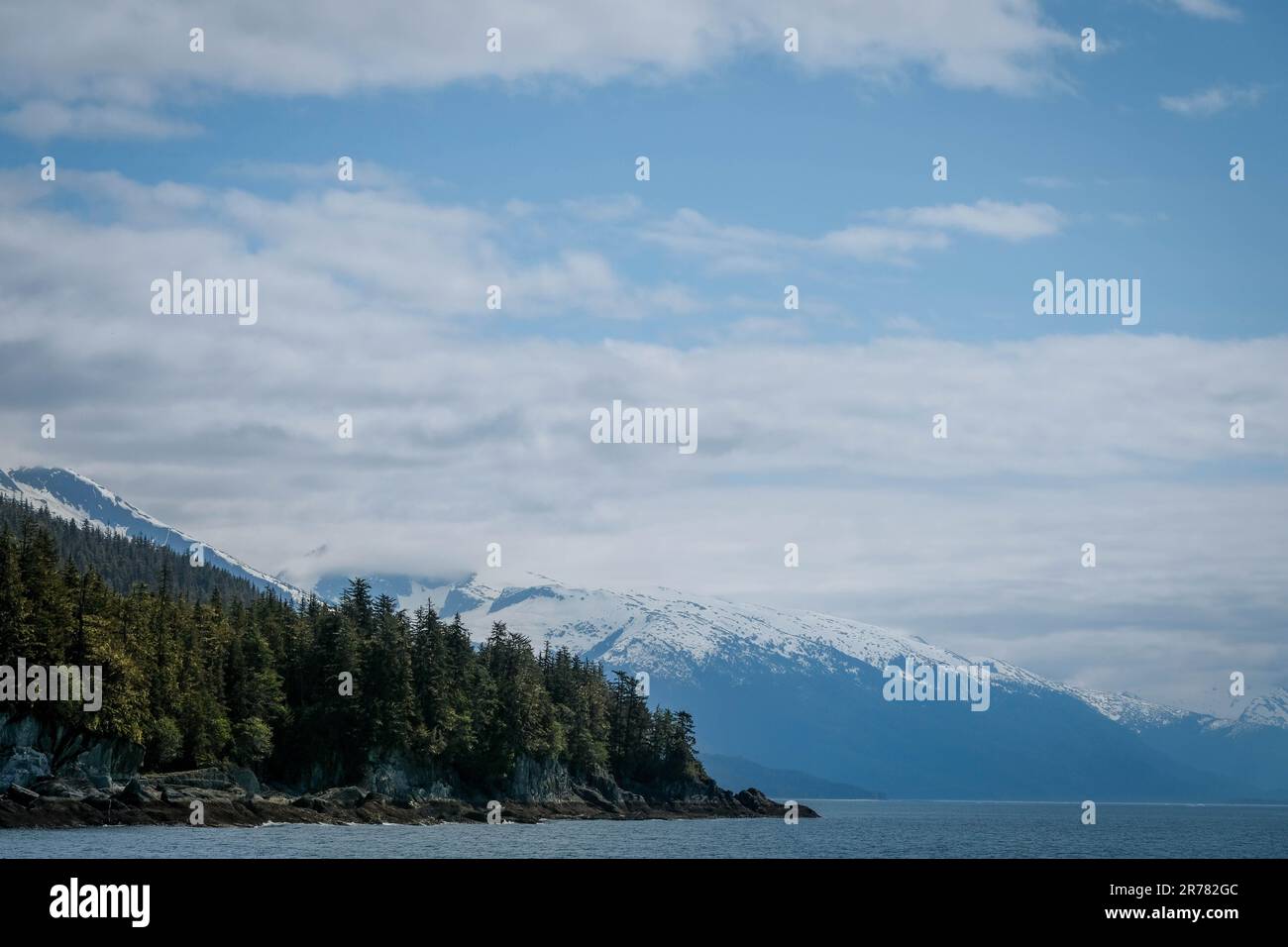 Les nuages bas sur les montagnes enneigées et la mer en Alaska Banque D'Images