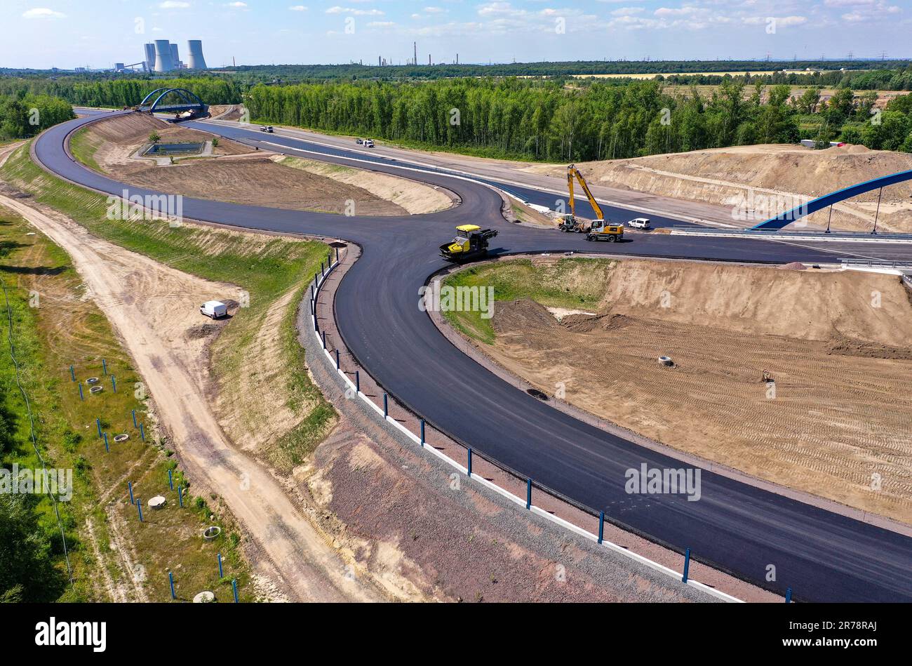 12 juin 2023, Saxe, Böhlen: La première couche d'asphalte a déjà été appliquée à la future chaussée du A72 à la jonction de Zwenkau près de Großdeuben. L'écart entre le A72 et le A38 devrait être comblé d'ici la mi-juillet. D'ici 2026, la plus grande partie de la nouvelle construction devrait être achevée et le trafic de la région de Vogtland à Leipzig pourra se déplacer sur deux voies. La construction de la fermeture de l'écart est complexe parce que la route traverse les terrains de déversement d'une ancienne mine à ciel ouvert. (Photo aérienne avec drone) photo: Jan Woitas/dpa Banque D'Images