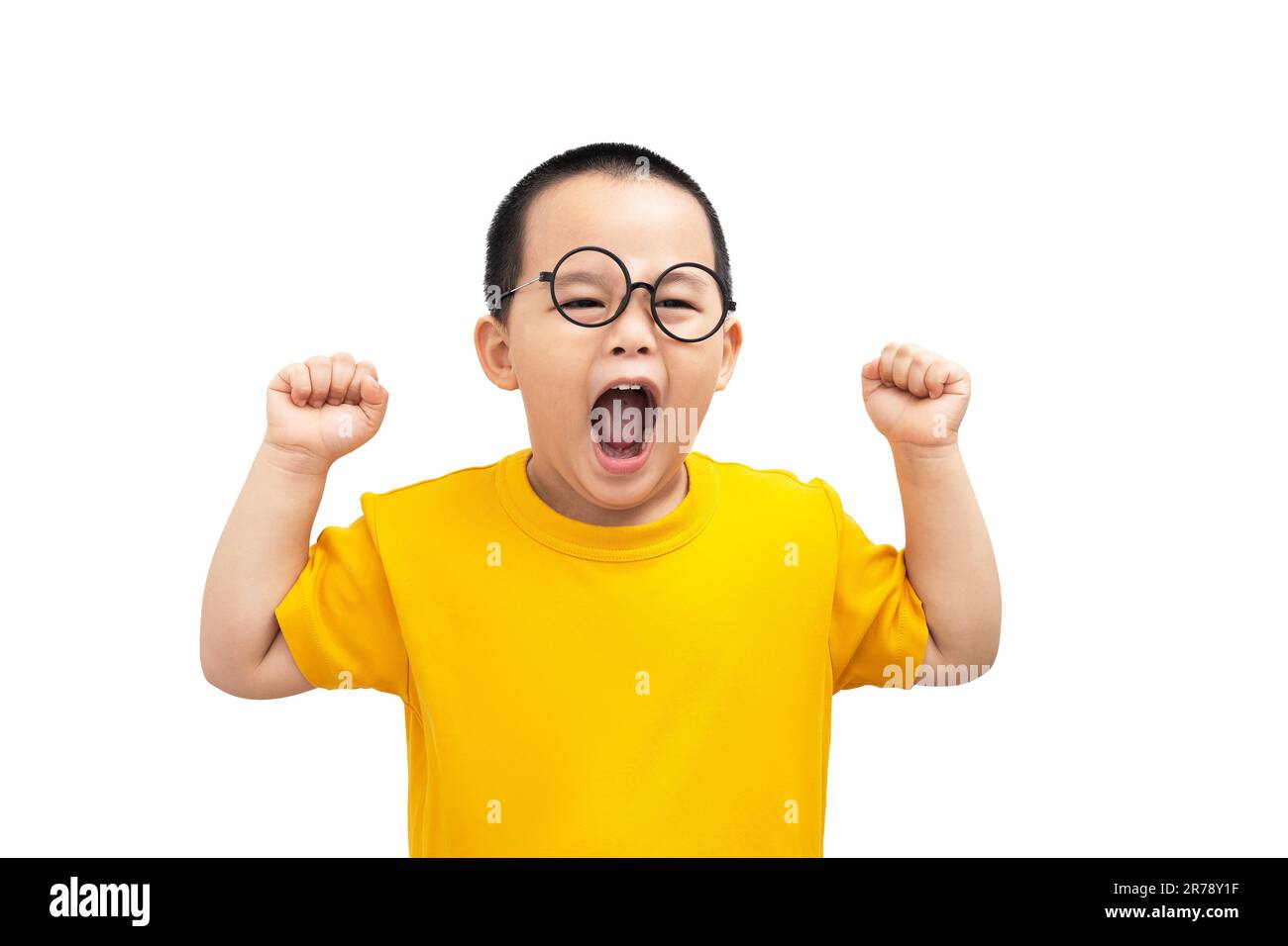 Petit garçon portant décontracté jaune T-shirt debout sur un arrière-plan blanc isolé très heureux et excité faisant le geste gagnant avec les bras relevés, smilin Banque D'Images