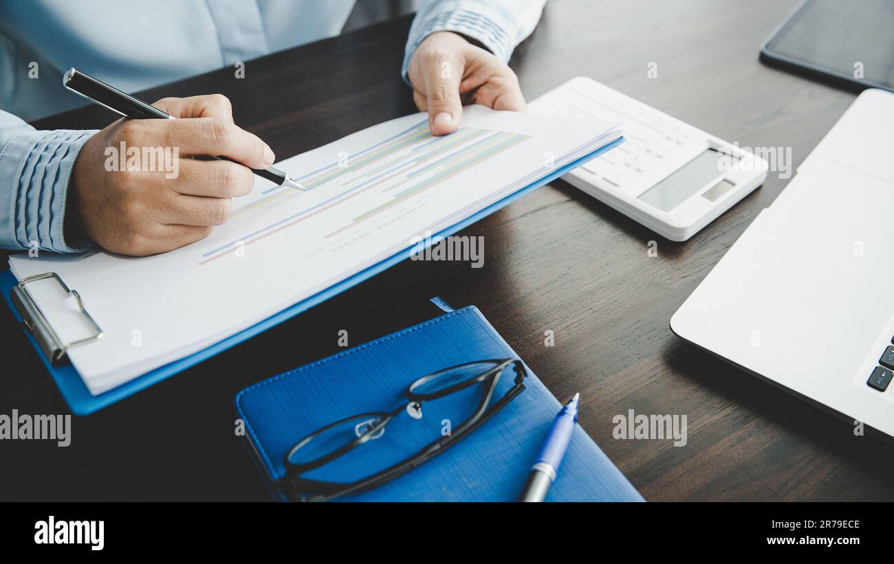 Femme d'affaires professionnelle travaillant au bureau. Business Woman main Analysis graphique documenter les finances sur la paperasse avec des données de graphique et de marketing Banque D'Images Femme d'affaires professionnelle travaillant au bureau. Business Woman main Analysis graphique documenter les finances sur la paperasse avec des données de graphique et de marketing Banque D'Images