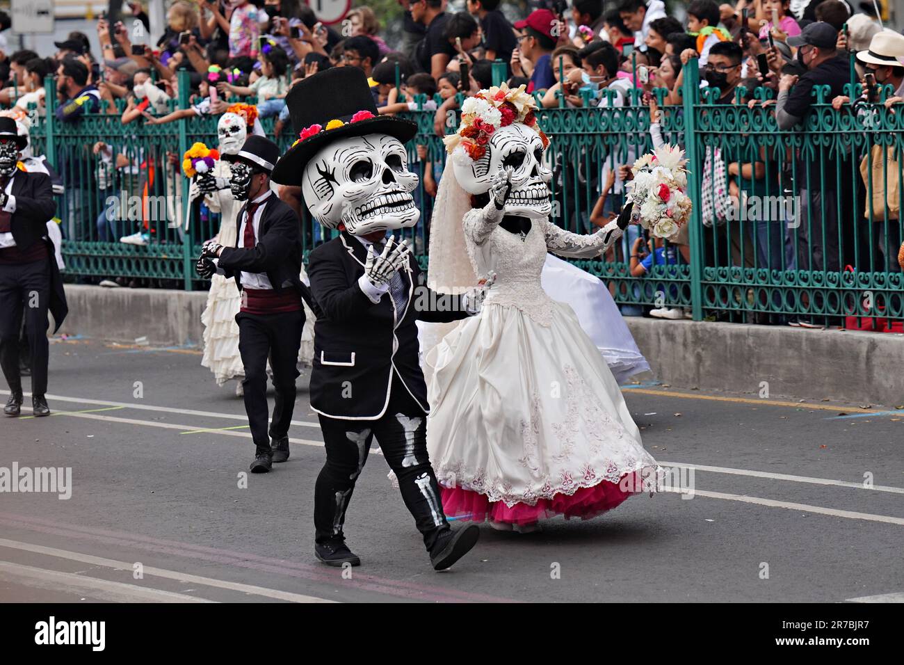 Des artistes portant des masques à crâne géant se font la vague devant les spectateurs lors de la Grande Parade des morts pour célébrer les vacances de Dia de los Muertos sur le Paseo de la Reforma, à 29 octobre 2022, à Mexico, au Mexique. Banque D'Images