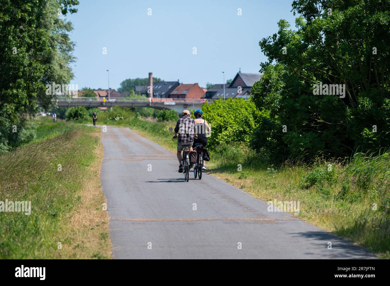 Wichelen, région flamande de l'est, Belgique - 4 juin 2023 - deux cyclistes qui traversent les bois et les prairies Banque D'Images