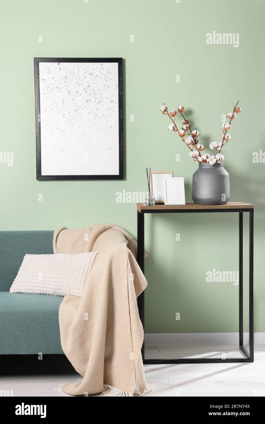 Branches avec fleurs de coton blanc moelleux sur la table de console dans la chambre confortable. Design intérieur Banque D'Images