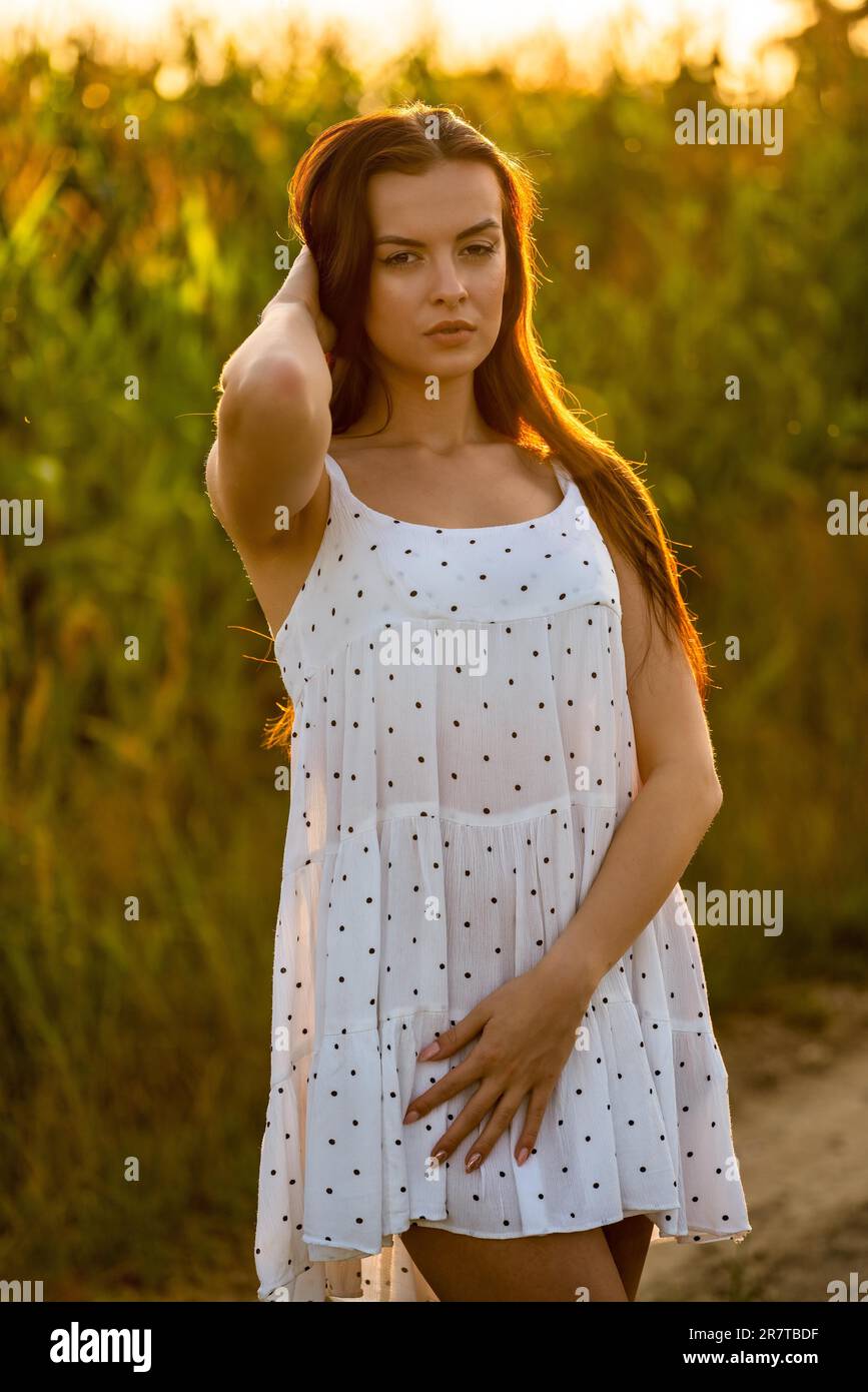 Jeune belle femme en robe blanche dans champ de maïs Banque D'Images