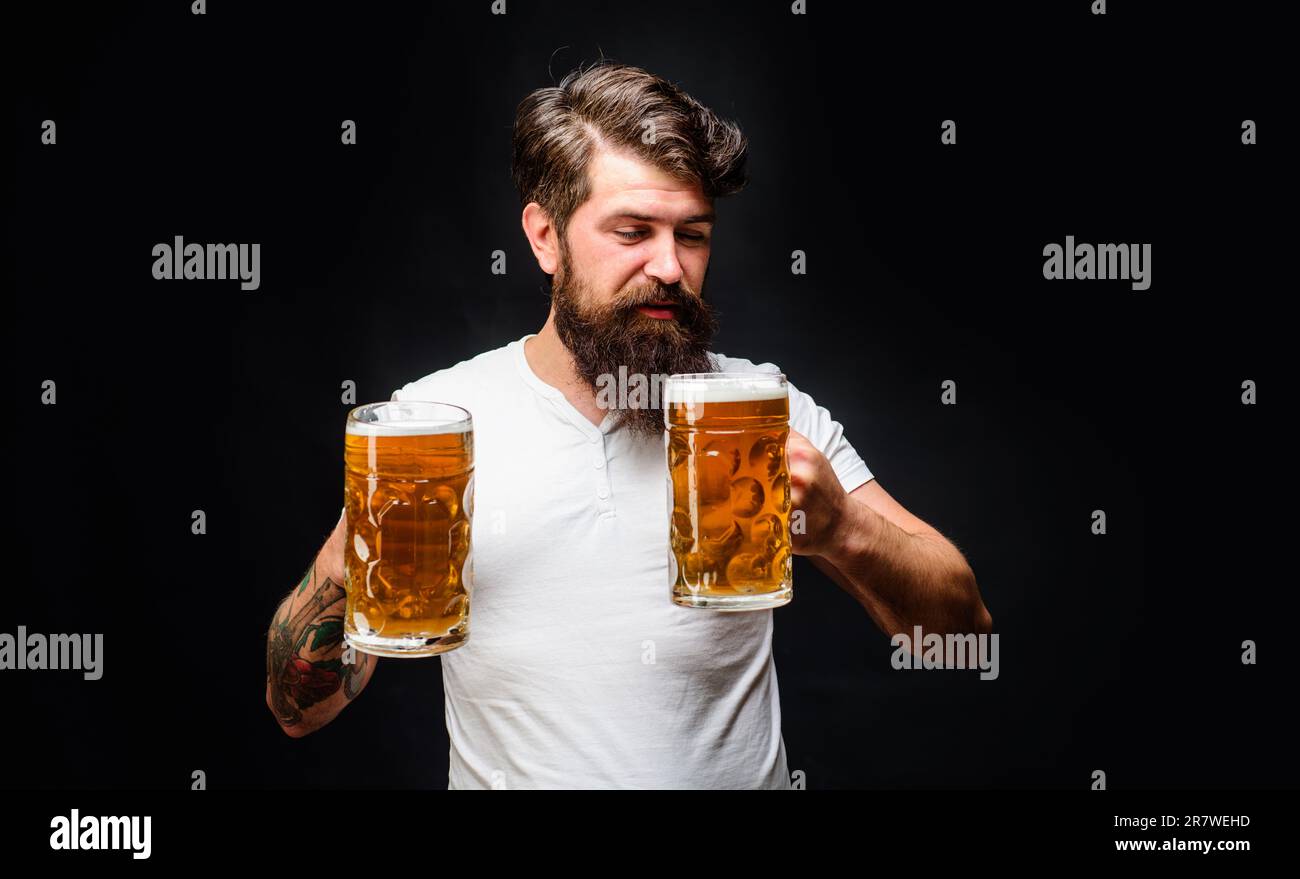 Homme satisfaisant avec deux tasses de bière. Alcool. Publicité au bar, au pub ou au restaurant. Beau homme appréciant une pinte froide de bière. Préparation du café. Durée de la bière. Oktoberf Banque D'Images