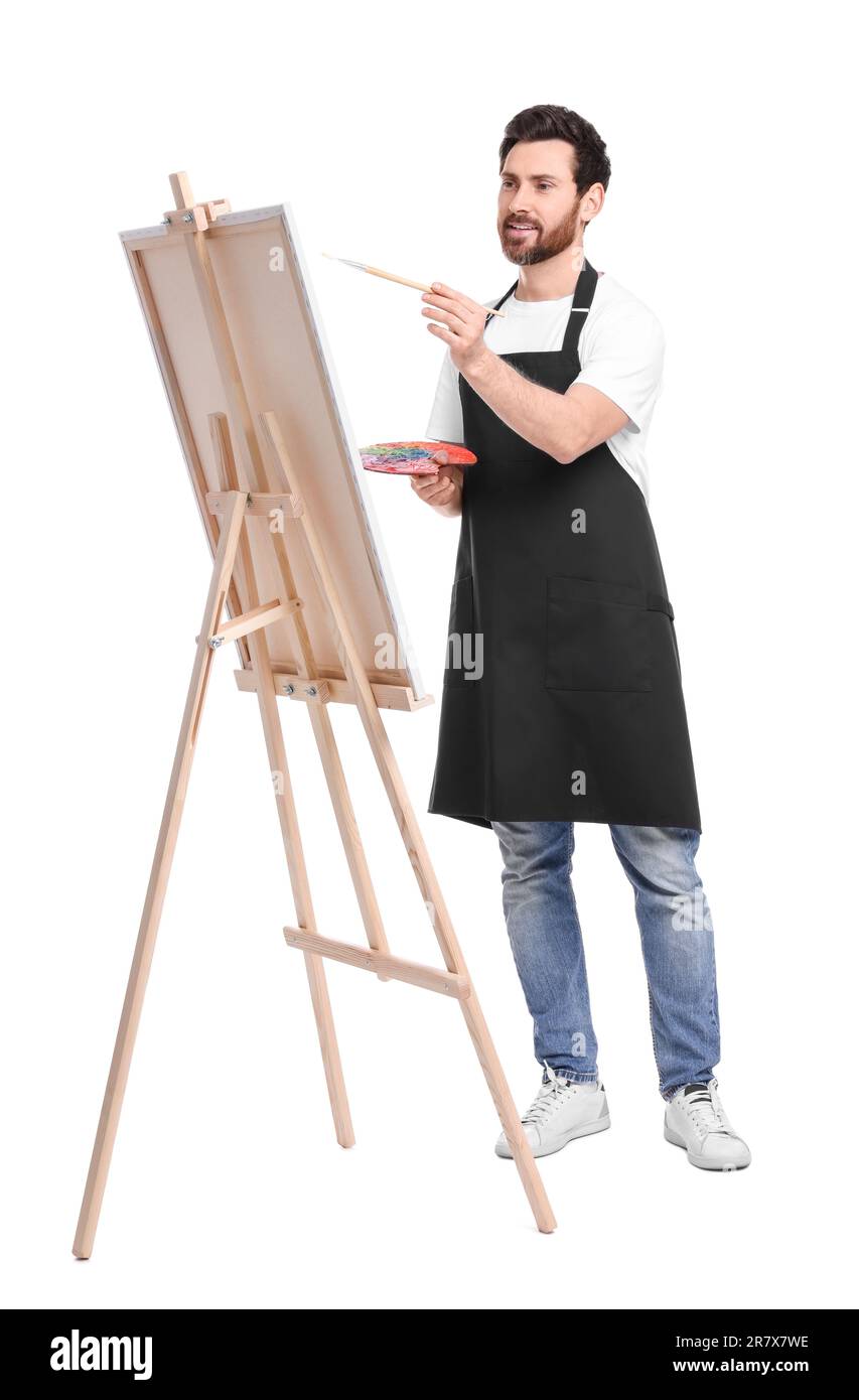 Artiste avec pinceau sur fond blanc. Utilisation du chevalet pour tenir la toile Banque D'Images