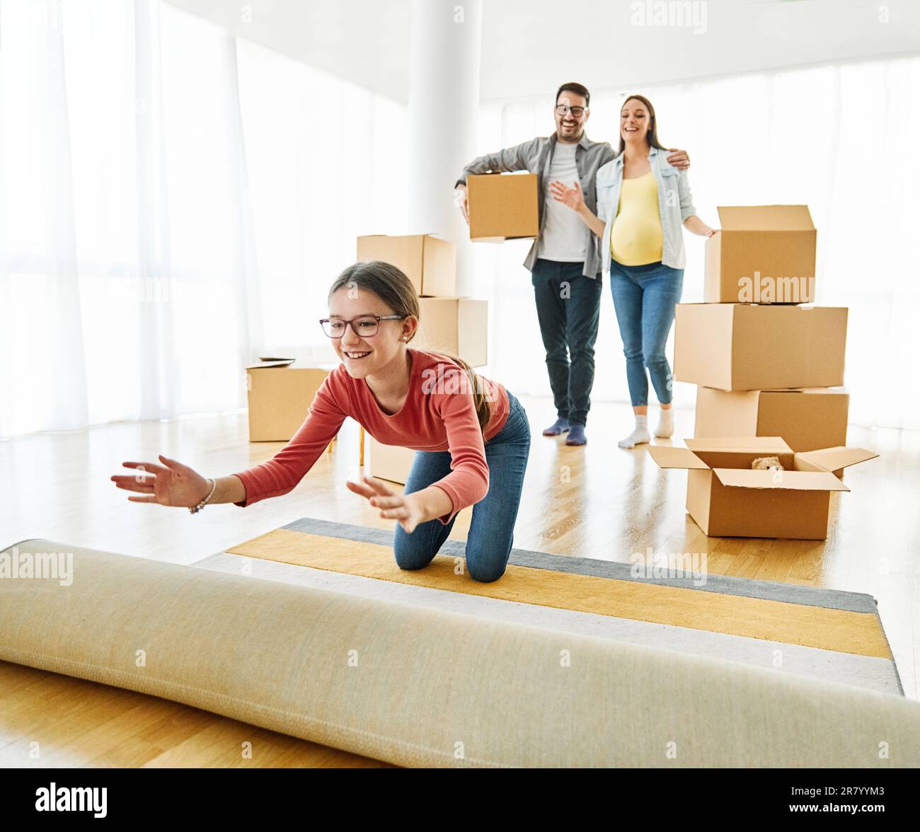 Portrait d'une belle famille avec une femme enceinte et une fille déménagent dans une nouvelle maison Banque D'Images