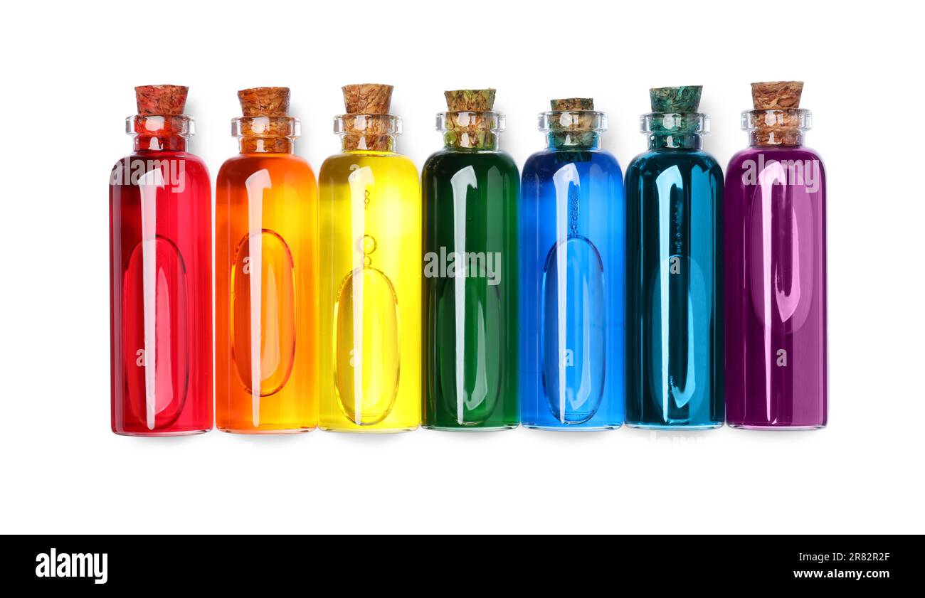 Flacons en verre avec différentes couleurs alimentaires sur fond blanc, vue de dessus Banque D'Images