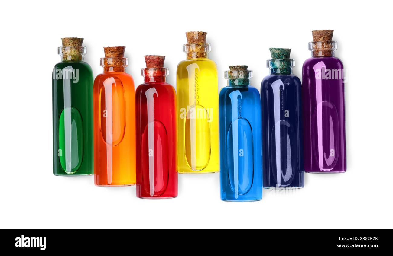Flacons en verre avec différentes couleurs alimentaires sur fond blanc, vue de dessus Banque D'Images