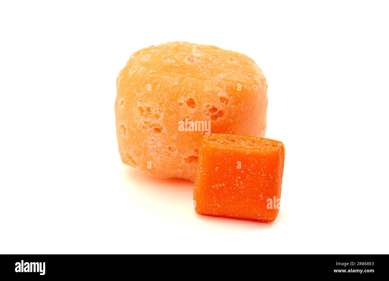 Gelée de Candy carrée à l'orange et une pièce originale côte à côte isolée sur un fond blanc Banque D'Images