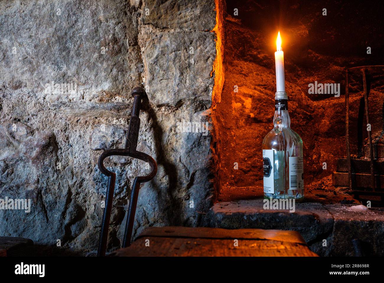 Une bougie dans une bouteille dans un vieux cottage en pierre Banque D'Images