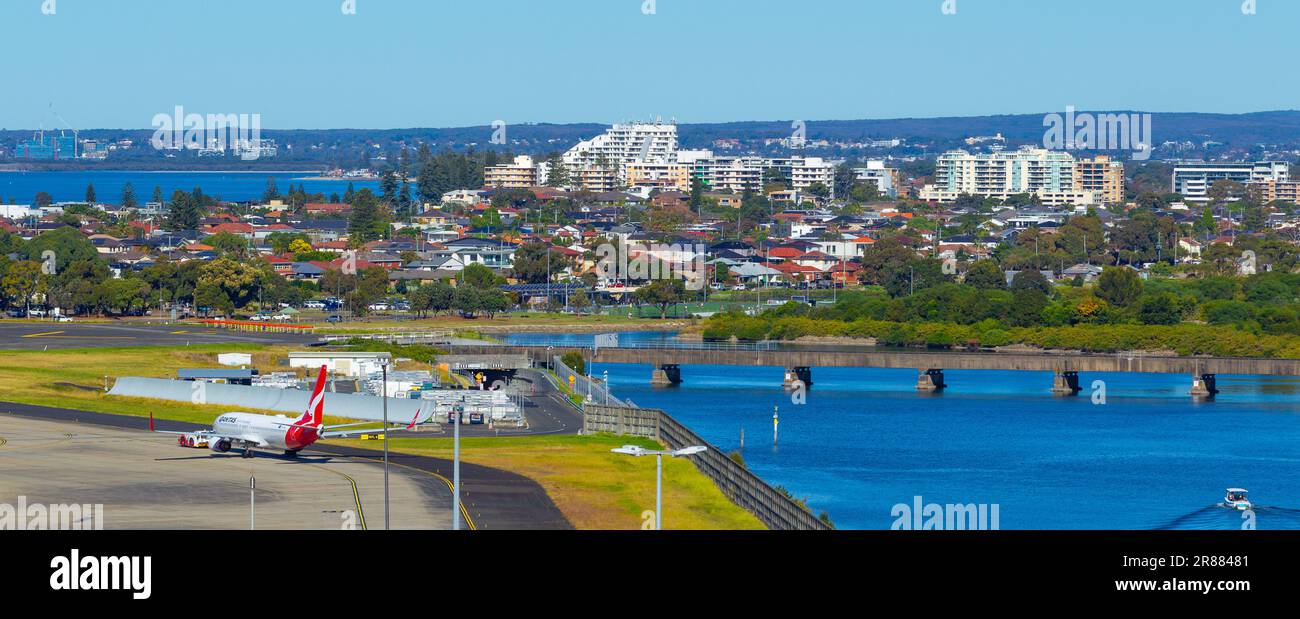 Le tablier sud-ouest de l'aéroport de Sydney en Australie, avec la rivière Cooks, Botany Bay et les banlieues de Kyeemagh et Brighton en arrière-plan. Banque D'Images