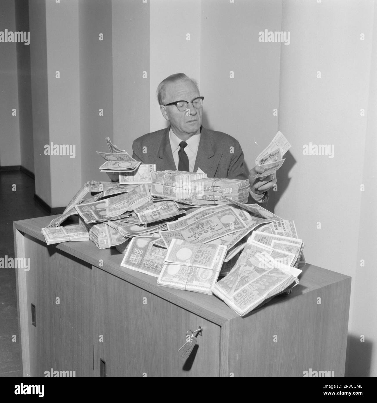 Courant 47-6-1960: Argent personne ne veut que le Trésor d'État gagne 1 1/4 millions de NOK chaque année parce que les gens ne réclament pas leurs gains dans les prêts d'obligations de loterie et de prime. Les loteries de marchandises font du travail de détective pour se débarrasser des voitures, téléviseurs et réfrigérateurs. Photo: Ivar Aaserud / Aktuell / NTB ***PHOTO NON TRAITÉE*** Banque D'Images