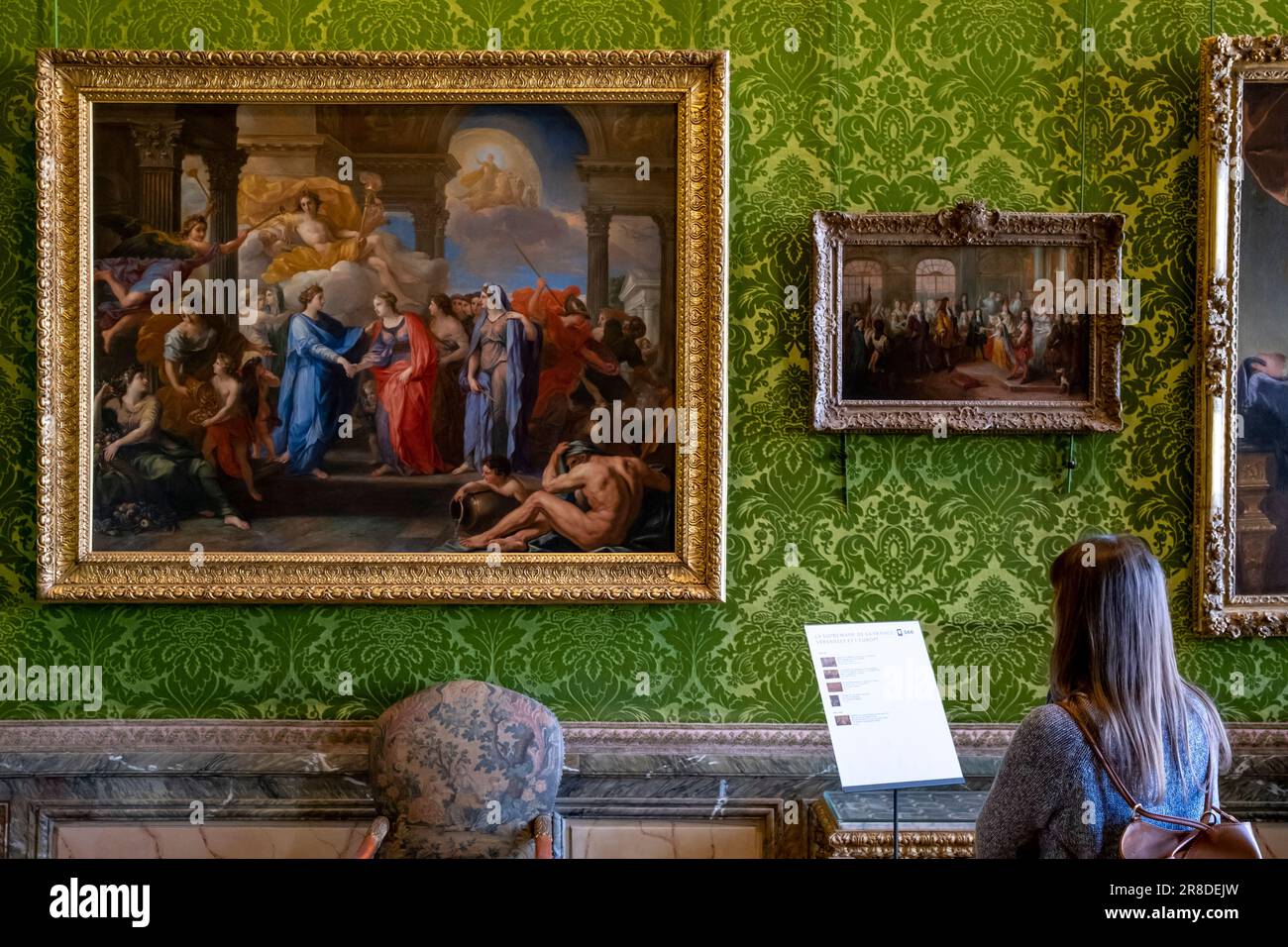 Une jeune femme regardant Une peinture à l'intérieur du château de Versailles, Versailles, France. Banque D'Images