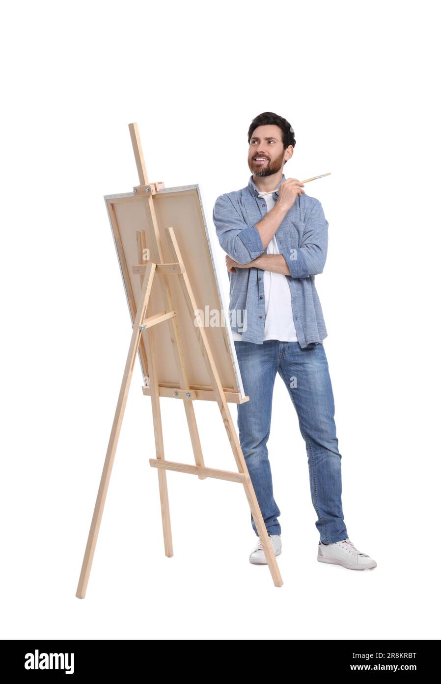 Joyeux homme peint sur fond blanc. Utilisation du chevalet pour tenir la toile Banque D'Images