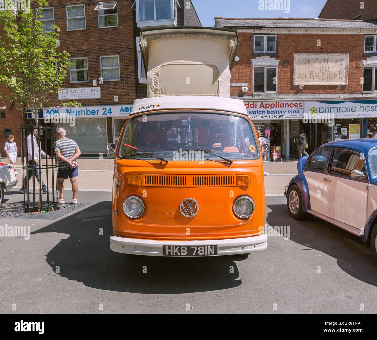 Un camping-car orange Volkswagen des années 1970 avec son toit élévateur relevé. VW camping-car au salon des voitures classiques et anciennes. Banque D'Images