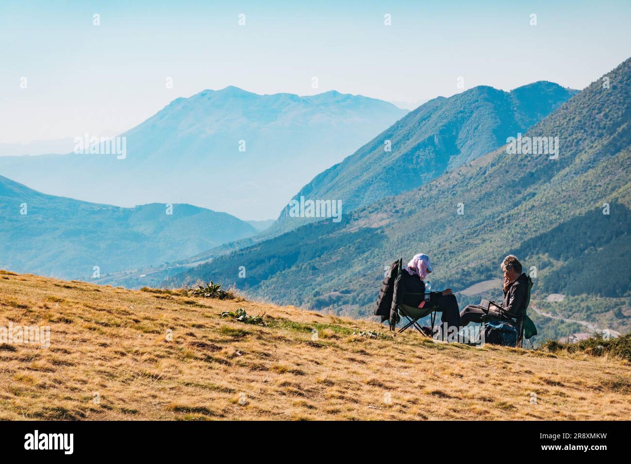 Les gens se détendent sur les pentes herbeuses de Prevalla Field un après-midi ensoleillé de week-end d'été à Prevalla, une ville de montagne au Kosovo Banque D'Images