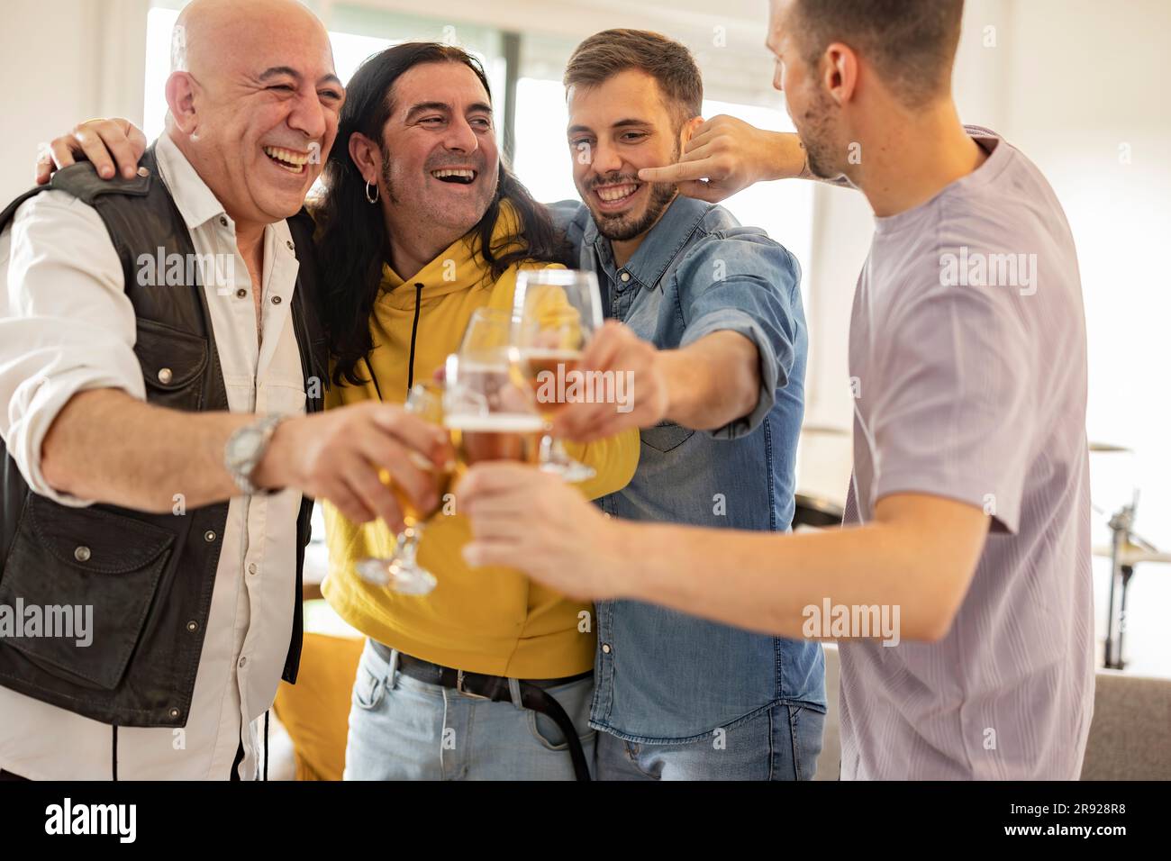 Des amis heureux fêtant avec des verres à bière à la maison Banque D'Images