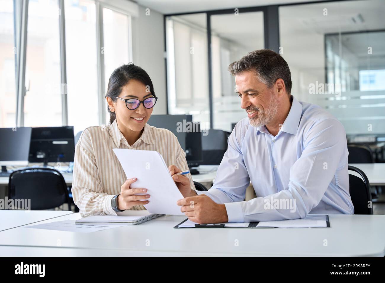 Divers collègues professionnels discutent de documents financiers travaillant au bureau. Banque D'Images