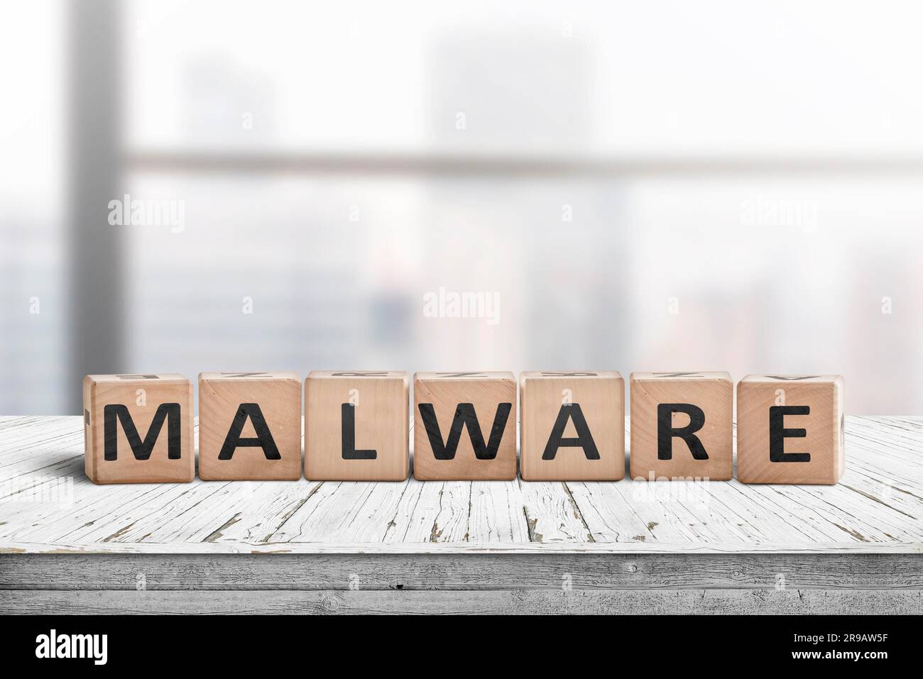 Panneau à message Malware fait de bois sur un bureau dans un environnement de bureau lumineux Banque D'Images