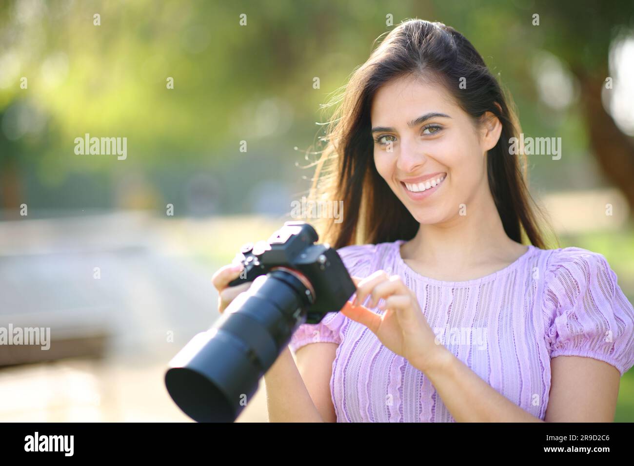 Un bon photographe qui vérifie votre appareil photo dans un parc Banque D'Images