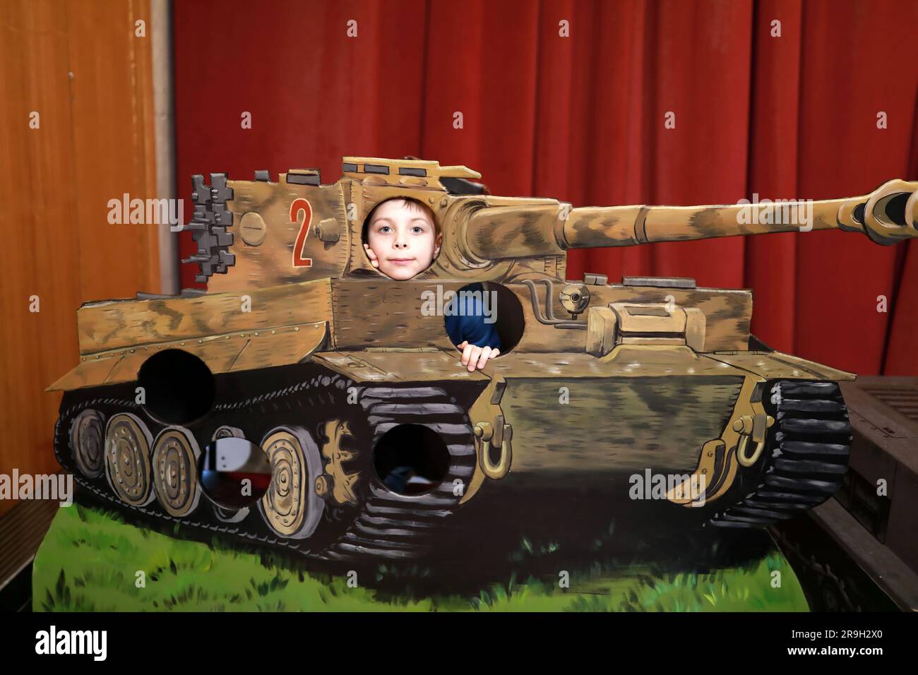 Portrait de l'enfant posant avec le modèle de réservoir Banque D'Images