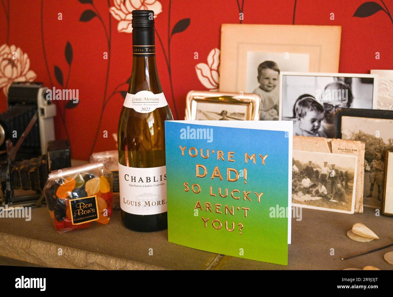 Carte de fête des pères et cadeaux de vin Chablis et gommes à vin exposés avec des photos de famille ancienne Banque D'Images