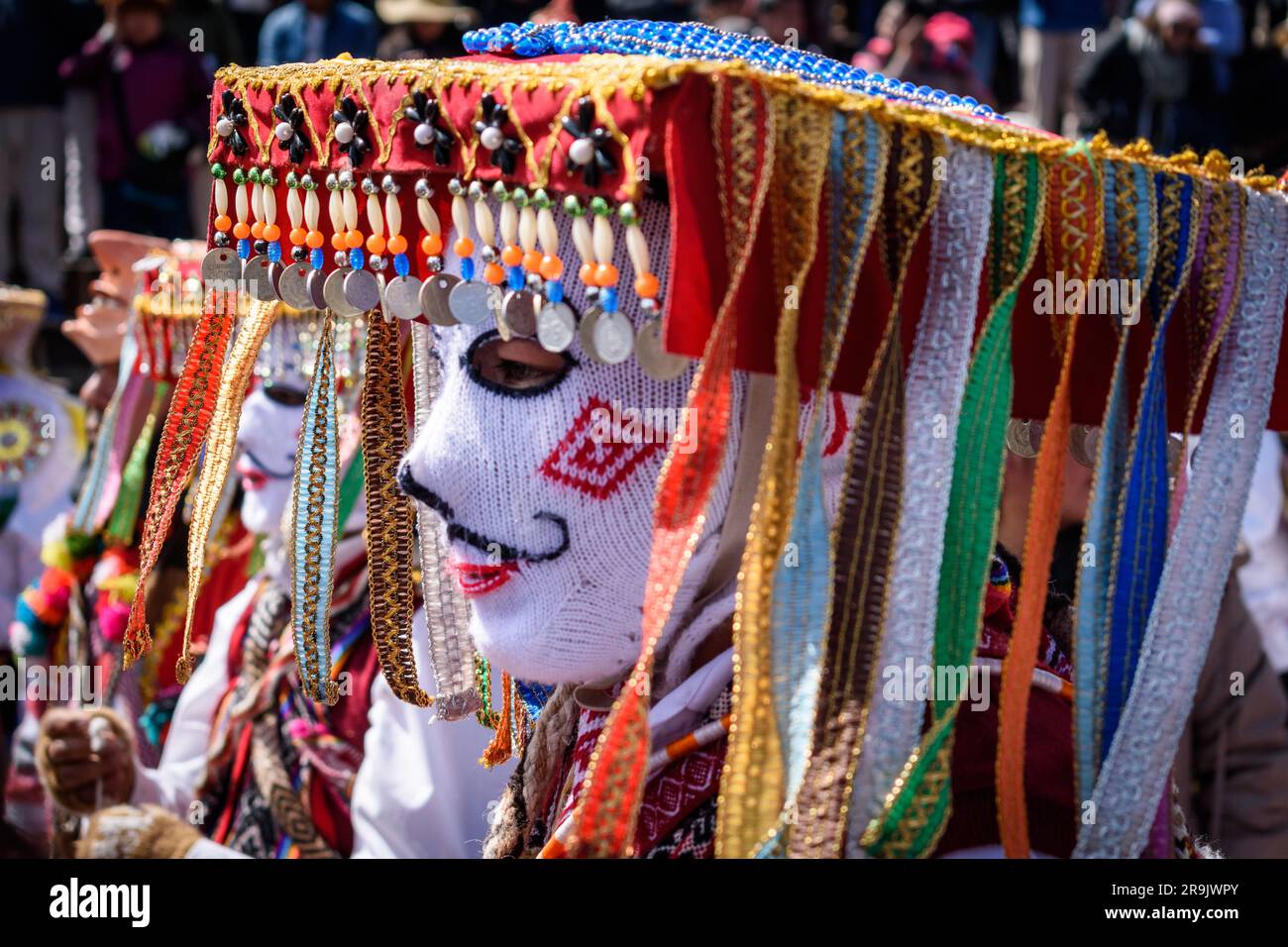 Cusco, une fête culturelle, des gens vêtus de costumes traditionnels colorés avec des masques et des chapeaux, des banderoles aux couleurs vives. Banque D'Images