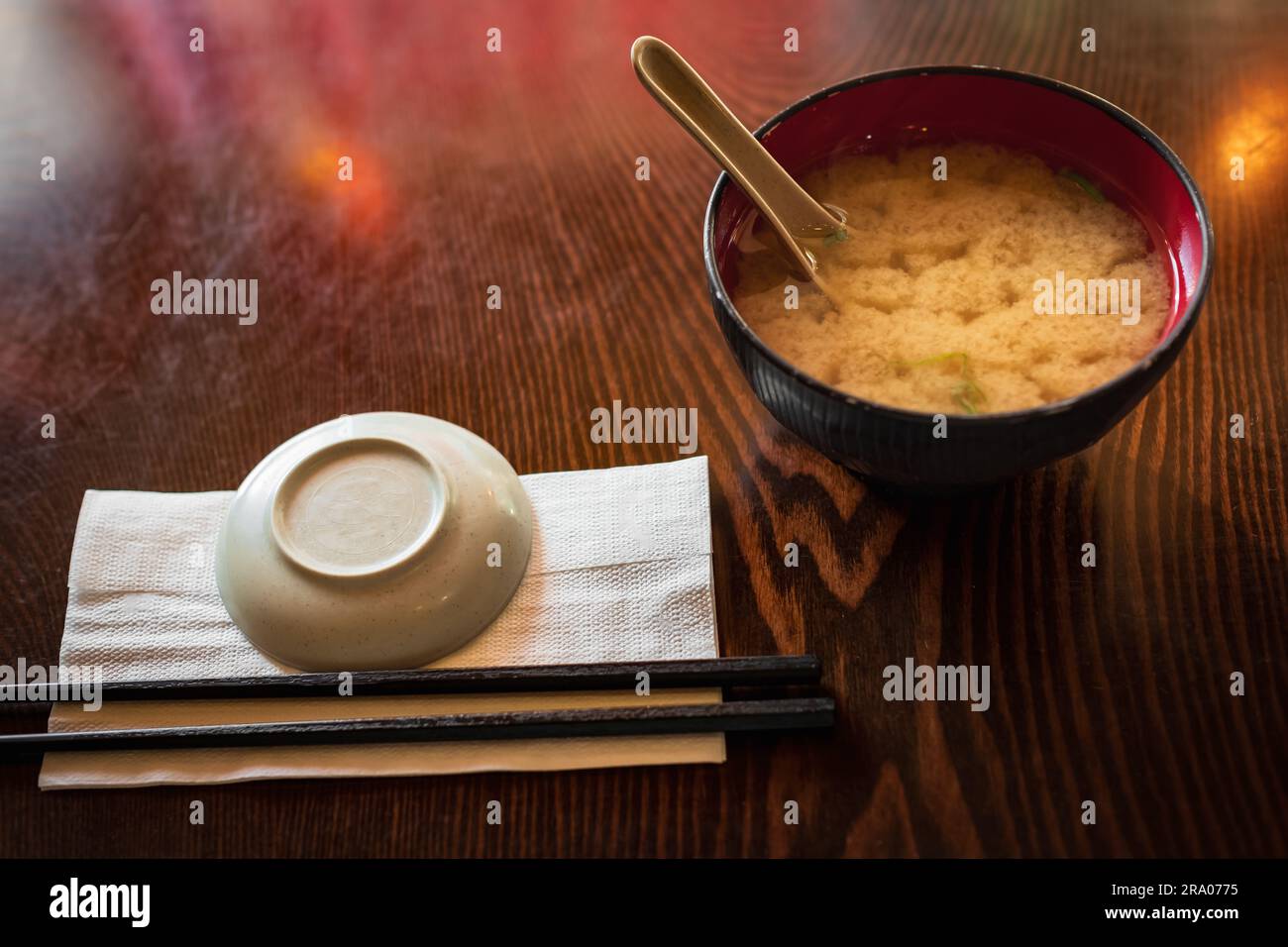 Soupe miso dans un bol dans un restaurant japonais local à Vancouver, en Colombie-Britannique. Soupe asiatique dans un bol avec baguettes. Personne, vue de dessus Banque D'Images